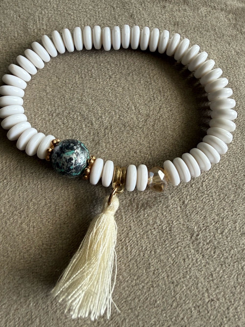 White Bead Stretch Bracelet with Cream Tassel and Green Accent